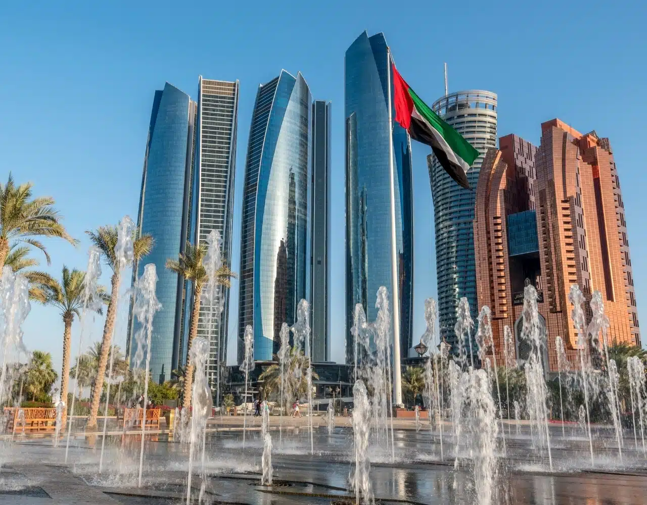 Etihad Towers in Abu Dhabi with fountains and UAE flag on a private city tour